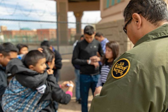 U.S. Border Patrol agent apprehends migrants (Public Domain)