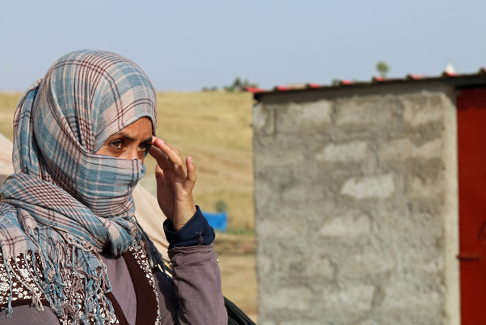 A Yazidi woman who escaped abuse from ISIS outside her tent in Kanke refugee camp (Photo by Thomas Koch, Shutterstock.com)